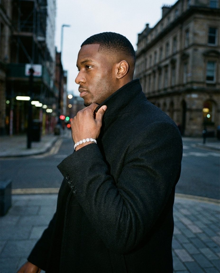Samedi model in a black coat on a London street wearing a moissanite bracelet