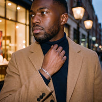 Atlas Figaro Bracelet 7mm worn with a camel overcoat and navy roll-neck on Marylebone High Street at dusk