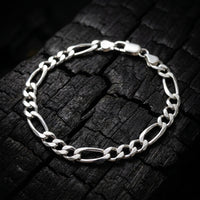 Atlas Figaro bracelet in solid 925 sterling silver on charred oak