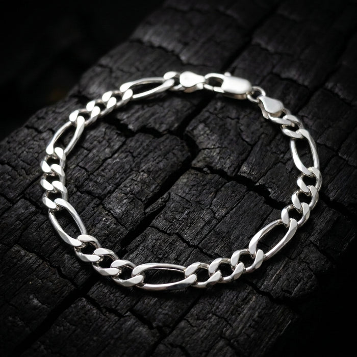 Atlas Figaro bracelet in solid 925 sterling silver on charred oak