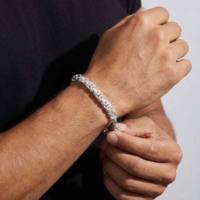 Fastening the lobster clasp on the King's Byzantine bracelet